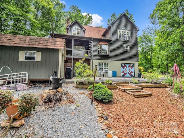 321 River Ridge Parkway, Rutherfordton, NC 28139 - back of property with a vegetable garden, a chimney, roof with shingles, and log exterior