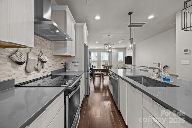 336 Uptown W Dr, Charlotte, NC 28208 - kitchen featuring wall chimney exhaust hood, stainless steel appliances, dark wood-style flooring, recessed lighting, and a sink