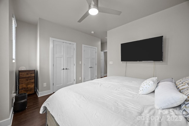 336 Uptown W Dr, Charlotte, NC 28208 - bedroom with dark wood-style flooring, two closets, baseboards, and ceiling fan