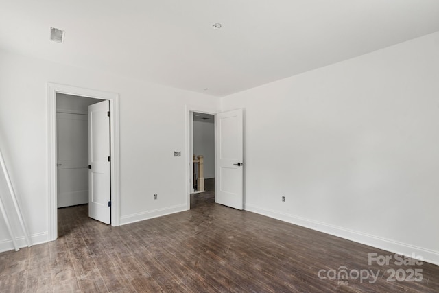 4315 Palm Dr, Denver, NC 28037 - unfurnished bedroom with wood finished floors, baseboards, and a walk in closet