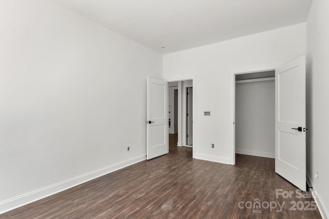 4315 Palm Dr, Denver, NC 28037 - unfurnished bedroom with dark wood-style flooring, baseboards, and a closet