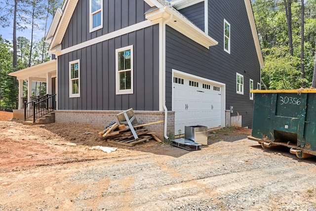 4315 Palm Dr, Denver, NC 28037 - view of side of property featuring board and batten siding, an attached garage, and driveway
