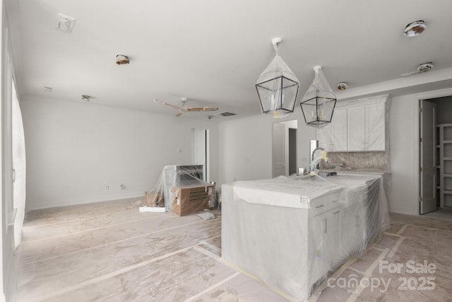 4315 Palm Dr, Denver, NC 28037 - kitchen with white cabinets, decorative light fixtures, light stone countertops, and a kitchen island