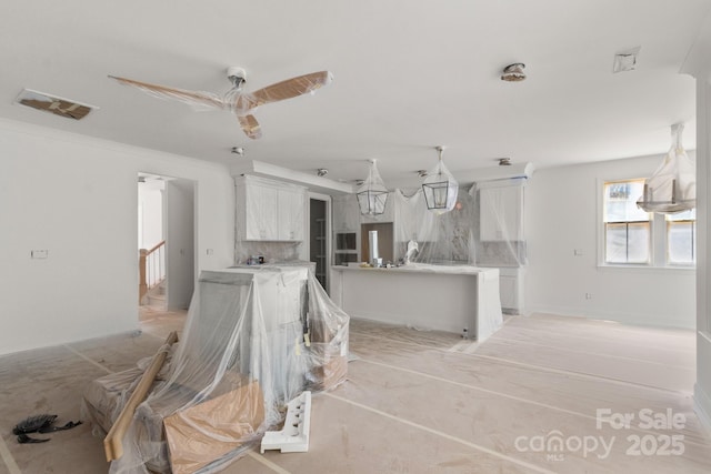 4315 Palm Dr, Denver, NC 28037 - kitchen with white cabinetry, light countertops, a ceiling fan, and a center island