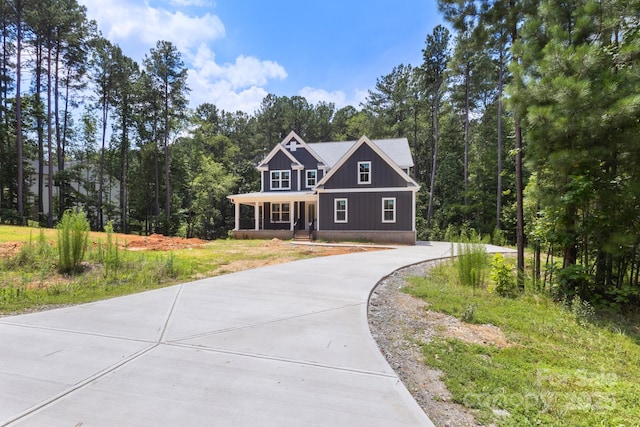 4315 Palm Dr, Denver, NC 28037 - craftsman inspired home with a porch, concrete driveway, and a view of trees