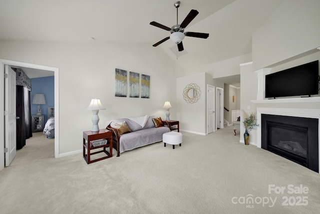 6192 Kilchurn Dr, Fort Mill, SC 29707 - carpeted living area with ceiling fan, a glass covered fireplace, and high vaulted ceiling