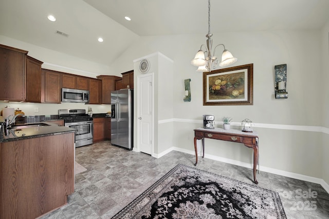 6192 Kilchurn Dr, Fort Mill, SC 29707 - kitchen with appliances with stainless steel finishes, dark countertops, a chandelier, lofted ceiling, and hanging light fixtures