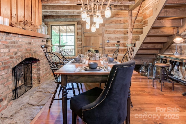 30 Wagon Mountain Dr, Weaverville, NC 28787 - dining space featuring wooden walls, wood finished floors, a brick fireplace, and stairway