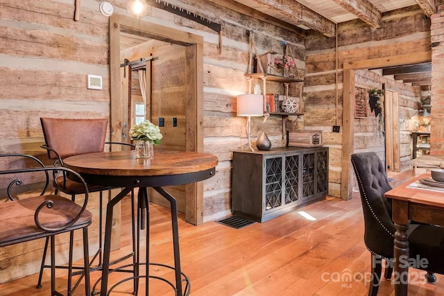 30 Wagon Mountain Dr, Weaverville, NC 28787 - dining space with wooden walls, hardwood / wood-style floors, and beamed ceiling