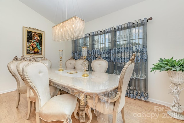12822 Plumleaf Dr, Charlotte, NC 28213 - dining room featuring a chandelier, wood finished floors, and baseboards