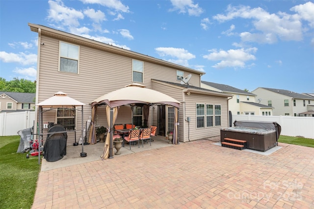 12822 Plumleaf Dr, Charlotte, NC 28213 - rear view of house with a gazebo, a hot tub, a patio, and a fenced backyard