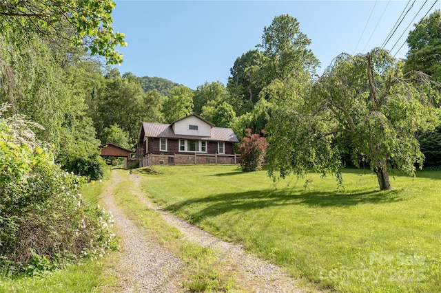 223 Smith Cove Rd, Candler, NC 28715 - view of front facade with driveway, metal roof, a front lawn, and stone siding