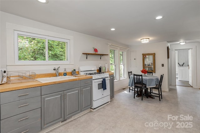 223 Smith Cove Rd, Candler, NC 28715 - kitchen featuring gray cabinetry, a sink, white range with gas cooktop, recessed lighting, and open shelves