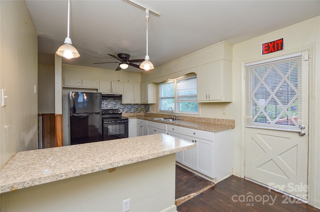 923 Yuma St, Charlotte, NC 28213 - kitchen with black appliances, a sink, under cabinet range hood, a peninsula, and dark wood-style floors