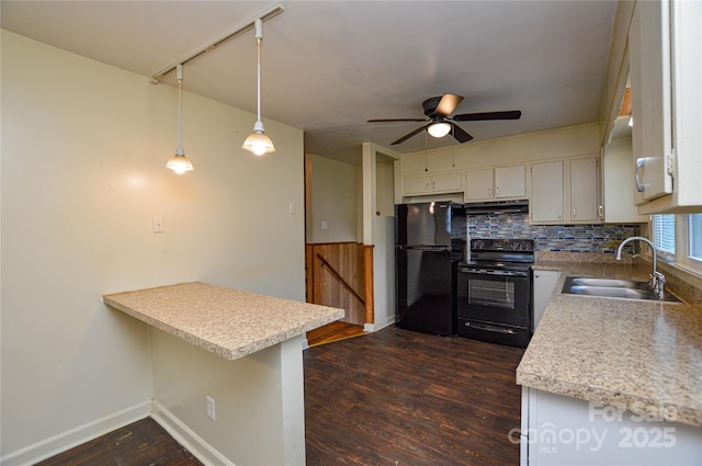 923 Yuma St, Charlotte, NC 28213 - kitchen with black appliances, a sink, under cabinet range hood, a peninsula, and light countertops