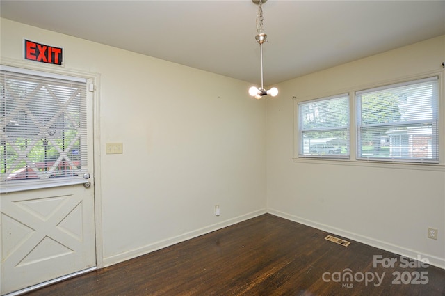 923 Yuma St, Charlotte, NC 28213 - unfurnished dining area with dark wood-type flooring and baseboards