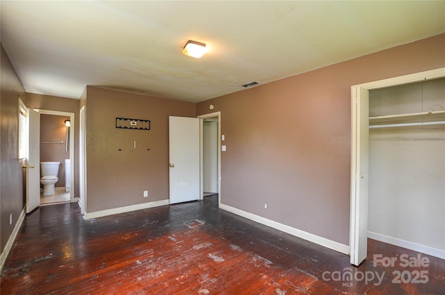 923 Yuma St, Charlotte, NC 28213 - unfurnished bedroom with baseboards, a closet, and wood finished floors
