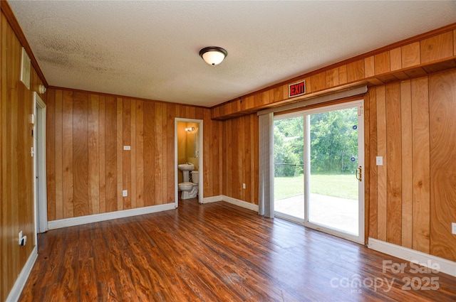 923 Yuma St, Charlotte, NC 28213 - spare room featuring wood finished floors, a textured ceiling, wooden walls, and baseboards