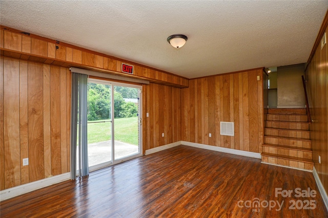 923 Yuma St, Charlotte, NC 28213 - unfurnished room featuring dark wood-style floors, baseboards, a textured ceiling, wooden walls, and stairway