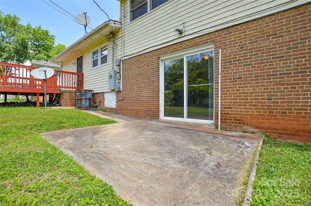 923 Yuma St, Charlotte, NC 28213 - view of home's exterior with a lawn, a deck, a patio area, brick siding, and central AC unit