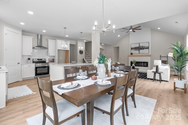 4949 Rimer Rd Unit 4, Concord, NC 28025 - dining area featuring a chandelier, a large fireplace, light wood finished floors, vaulted ceiling, and recessed lighting