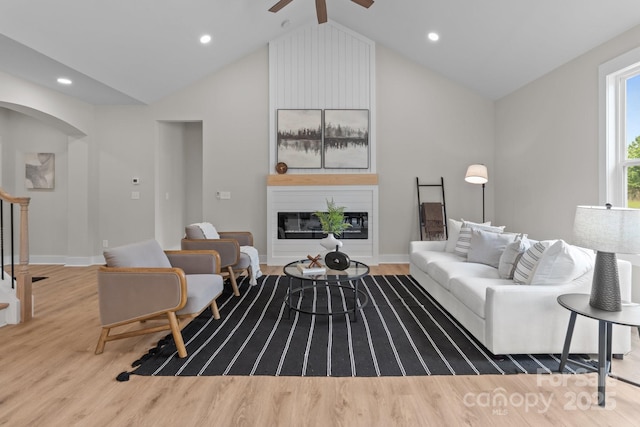 4949 Rimer Rd Unit 4, Concord, NC 28025 - living room with wood finished floors, a large fireplace, lofted ceiling, a ceiling fan, and arched walkways