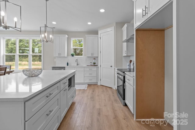 4949 Rimer Rd Unit 4, Concord, NC 28025 - kitchen featuring appliances with stainless steel finishes, a chandelier, white cabinets, light wood finished floors, and recessed lighting