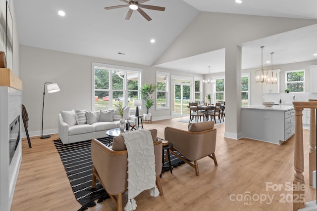 4949 Rimer Rd Unit 4, Concord, NC 28025 - living room with a chandelier, ceiling fan, a glass covered fireplace, high vaulted ceiling, and recessed lighting