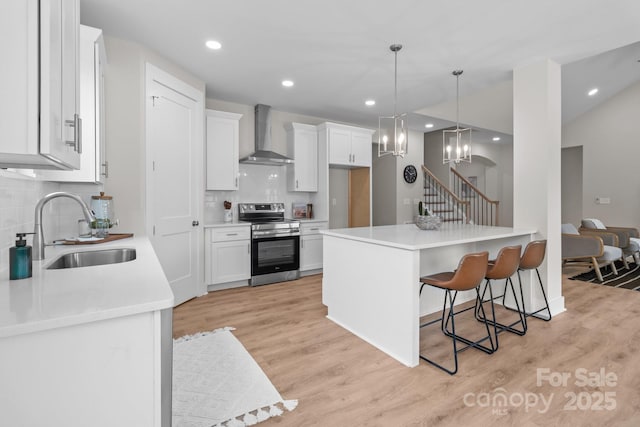 4949 Rimer Rd Unit 4, Concord, NC 28025 - kitchen with electric range, a sink, wall chimney exhaust hood, tasteful backsplash, and a breakfast bar area