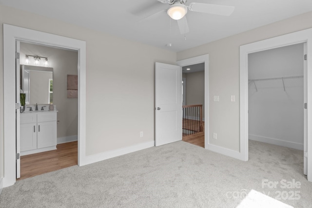 4949 Rimer Rd Unit 4, Concord, NC 28025 - unfurnished bedroom featuring carpet, a sink, a walk in closet, baseboards, and connected bathroom
