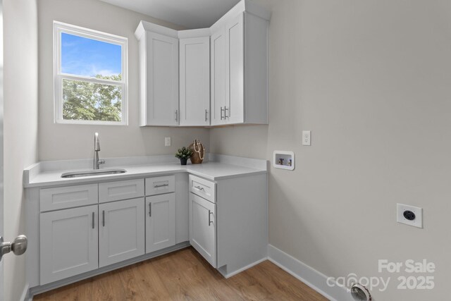 4949 Rimer Rd Unit 4, Concord, NC 28025 - washroom with hookup for a washing machine, electric dryer hookup, light wood-style flooring, baseboards, and cabinet space
