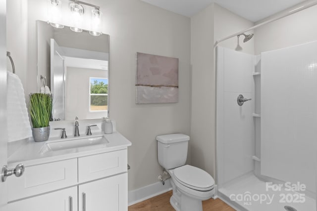 4949 Rimer Rd Unit 4, Concord, NC 28025 - bathroom featuring a stall shower, vanity, toilet, wood finished floors, and baseboards