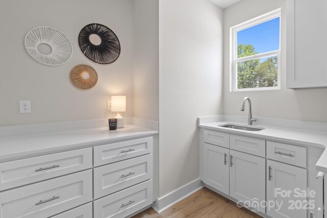 4949 Rimer Rd Unit 4, Concord, NC 28025 - kitchen with light countertops, light wood-style flooring, and white cabinets