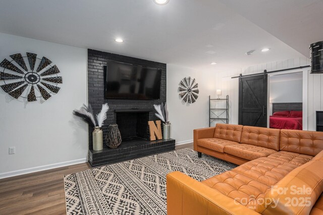 1761 Arden Dr, Lincolnton, NC 28092 - living area featuring a barn door, wood finished floors, recessed lighting, baseboards, and a fireplace