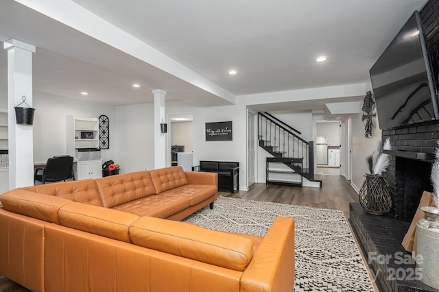 1761 Arden Dr, Lincolnton, NC 28092 - living room with wood finished floors, stairs, a brick fireplace, recessed lighting, and ornate columns