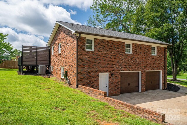 1761 Arden Dr, Lincolnton, NC 28092 - view of side of property featuring central air condition unit, an attached garage, concrete driveway, a lawn, and brick siding