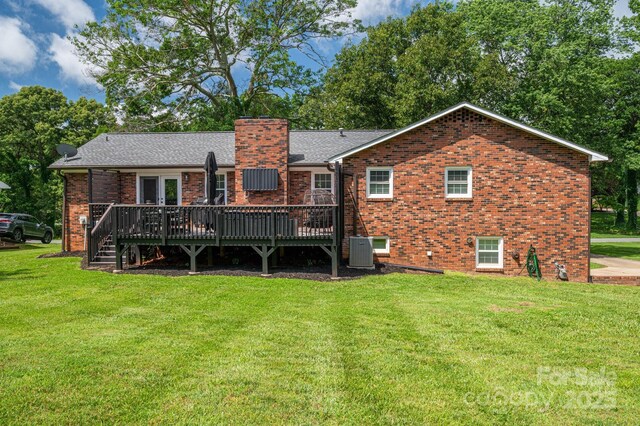 1761 Arden Dr, Lincolnton, NC 28092 - back of property with a deck, cooling unit, a lawn, and brick siding