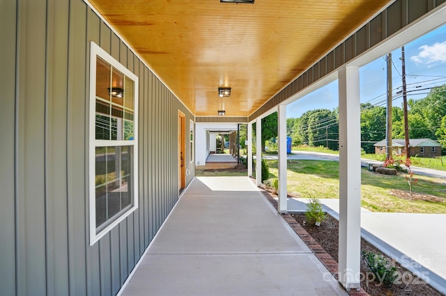 251 Hall Ave NW, Concord, NC 28027 - covered porch featuring view of wooded area