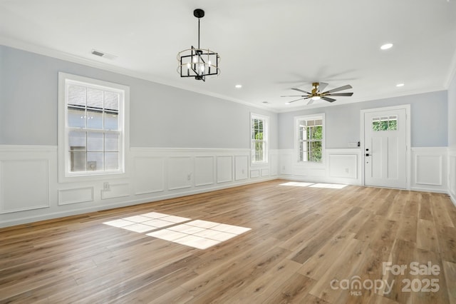 251 Hall Ave NW, Concord, NC 28027 - unfurnished room featuring a wainscoted wall, ornamental molding, a chandelier, ceiling fan, and a decorative wall