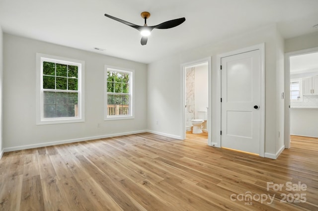 251 Hall Ave NW, Concord, NC 28027 - unfurnished bedroom with light wood-type flooring, baseboards, ensuite bath, and ceiling fan