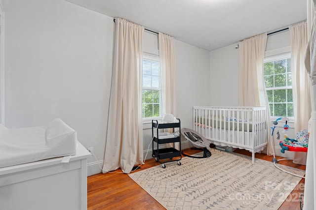 1211 11th St NW, Hickory, NC 28601 - bedroom with wood finished floors and a nursery area