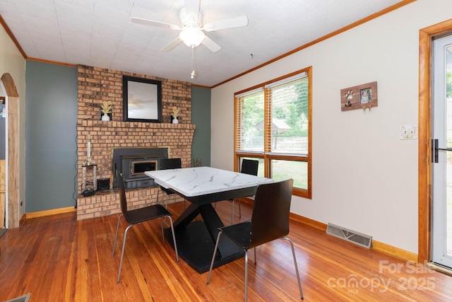 15 Gaddy Rd, Weaverville, NC 28787 - dining area with crown molding, hardwood / wood-style flooring, ceiling fan, and a brick fireplace