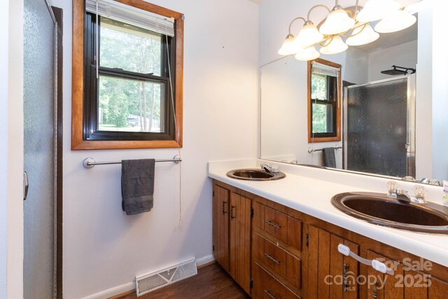 15 Gaddy Rd, Weaverville, NC 28787 - bathroom with a shower stall, double vanity, a chandelier, and wood finished floors