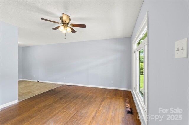 1075 Parkview Dr, Gastonia, NC 28054 - empty room with wood-type flooring, ceiling fan, and baseboards