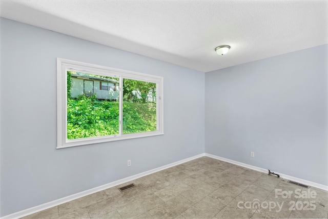 1075 Parkview Dr, Gastonia, NC 28054 - spare room with baseboards and a textured ceiling