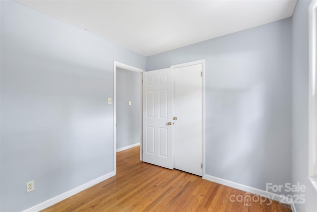 1075 Parkview Dr, Gastonia, NC 28054 - unfurnished bedroom with baseboards and light wood-type flooring