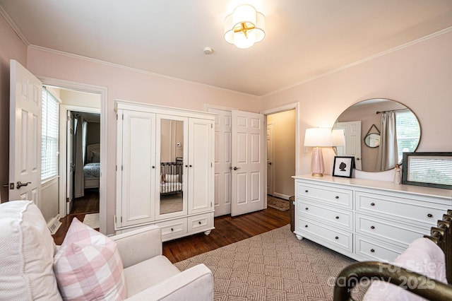 bedroom featuring dark wood-style flooring and ornamental molding