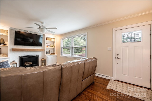 living area featuring a baseboard heating unit, crown molding, a fireplace, ceiling fan, and dark wood-style flooring