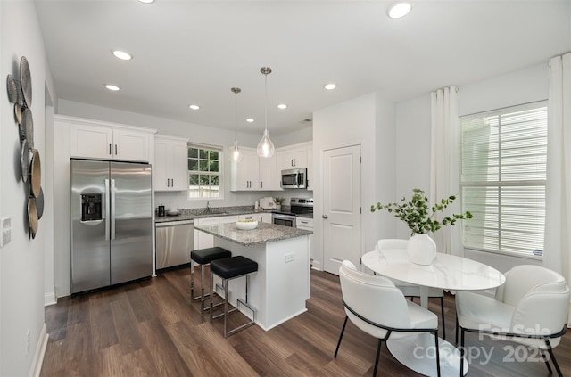 3004 Marlowe Ave, Charlotte, NC 28208 - kitchen with stainless steel appliances, a center island, dark wood-style floors, recessed lighting, and white cabinets