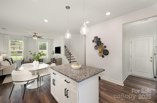 3004 Marlowe Ave, Charlotte, NC 28208 - kitchen featuring dark wood-type flooring, a center island, light stone countertops, open floor plan, and recessed lighting